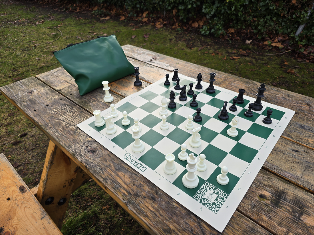 ChessKid Tote Chess Set with Vinyl Chess Board on Park Bench (Angled Shot from White&