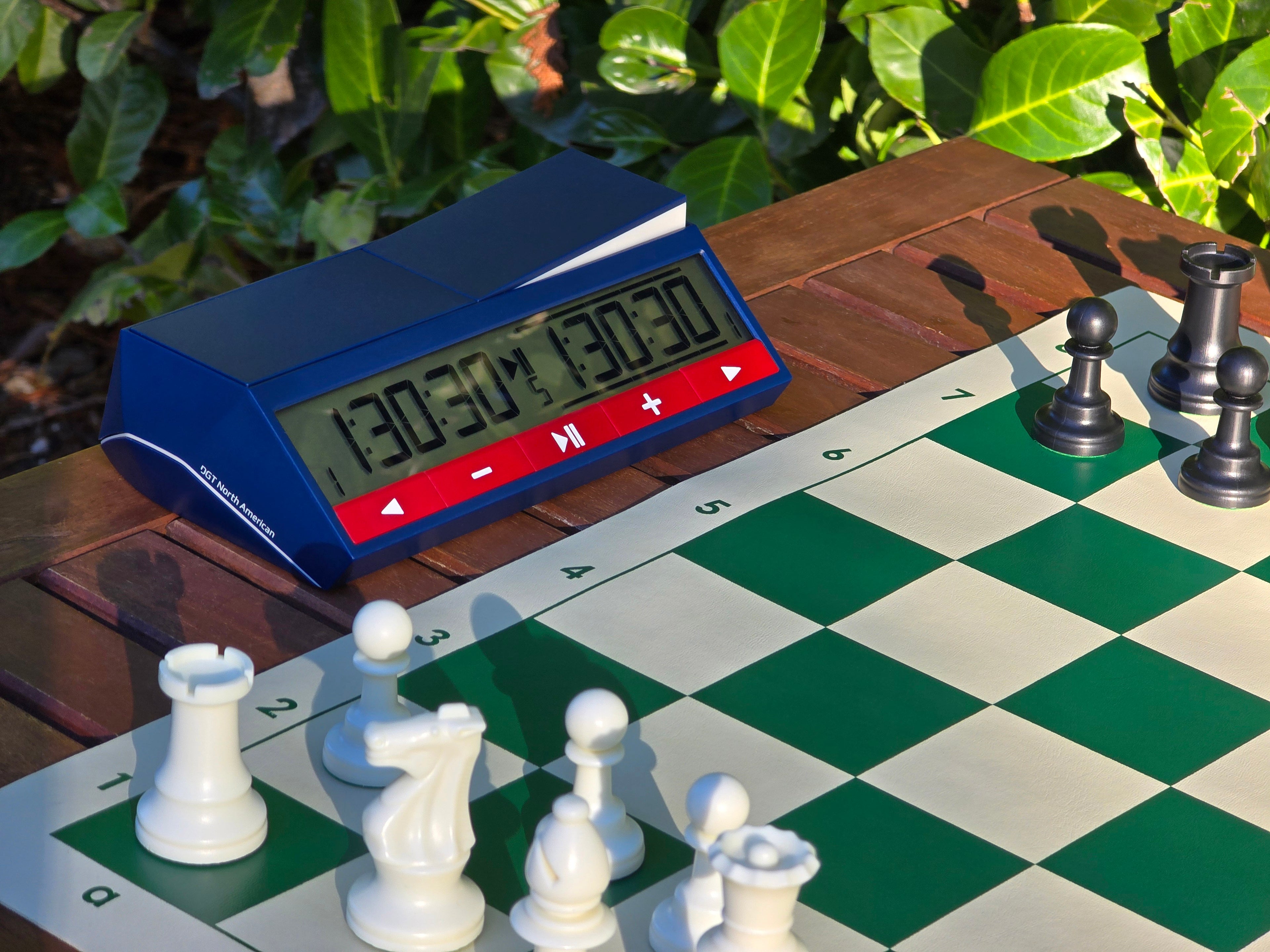 DGT North American 2024 Chess Clock Outdoors on a Half Chess Board
