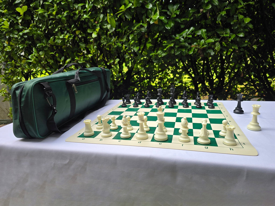 Deluxe Tournament Chess Set on a White Table with a Green Hedge Background
