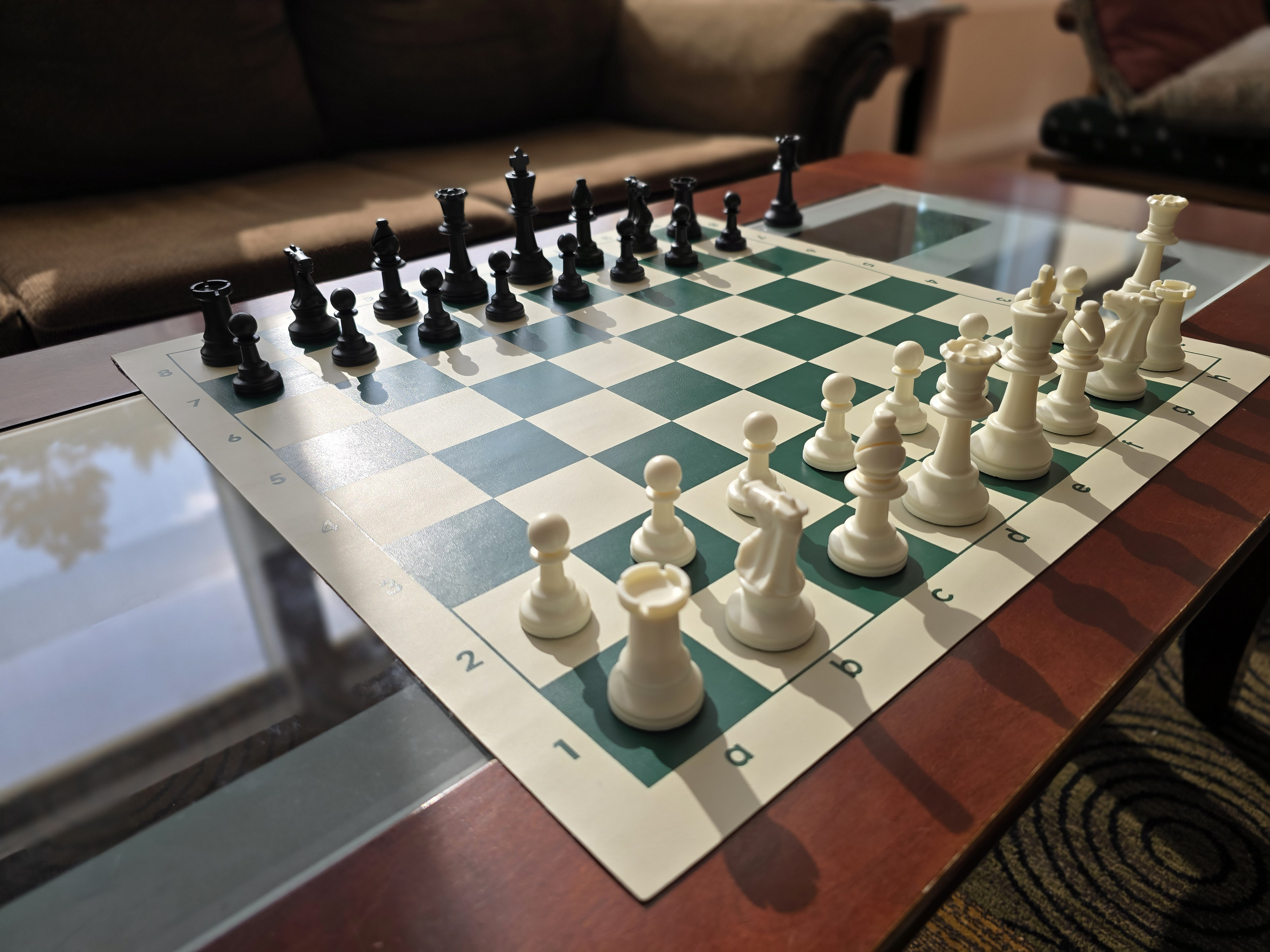 Tournament Chess Set on a Vinyl Chess Board on a Glass Coffee Table