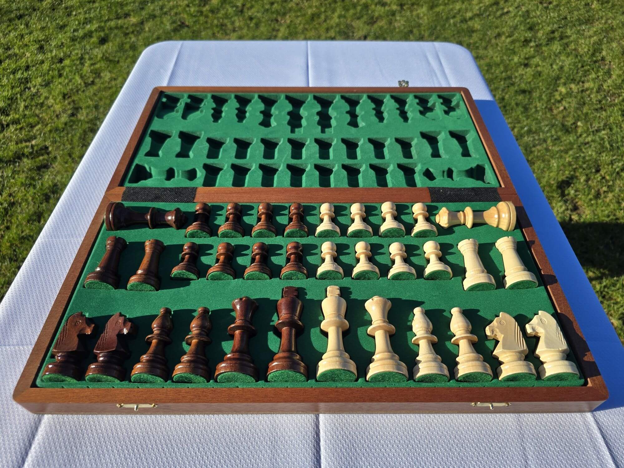 Opened Aristocrat wooden chess board showing the interior felt storage slots with green felt lining and full set of pieces.