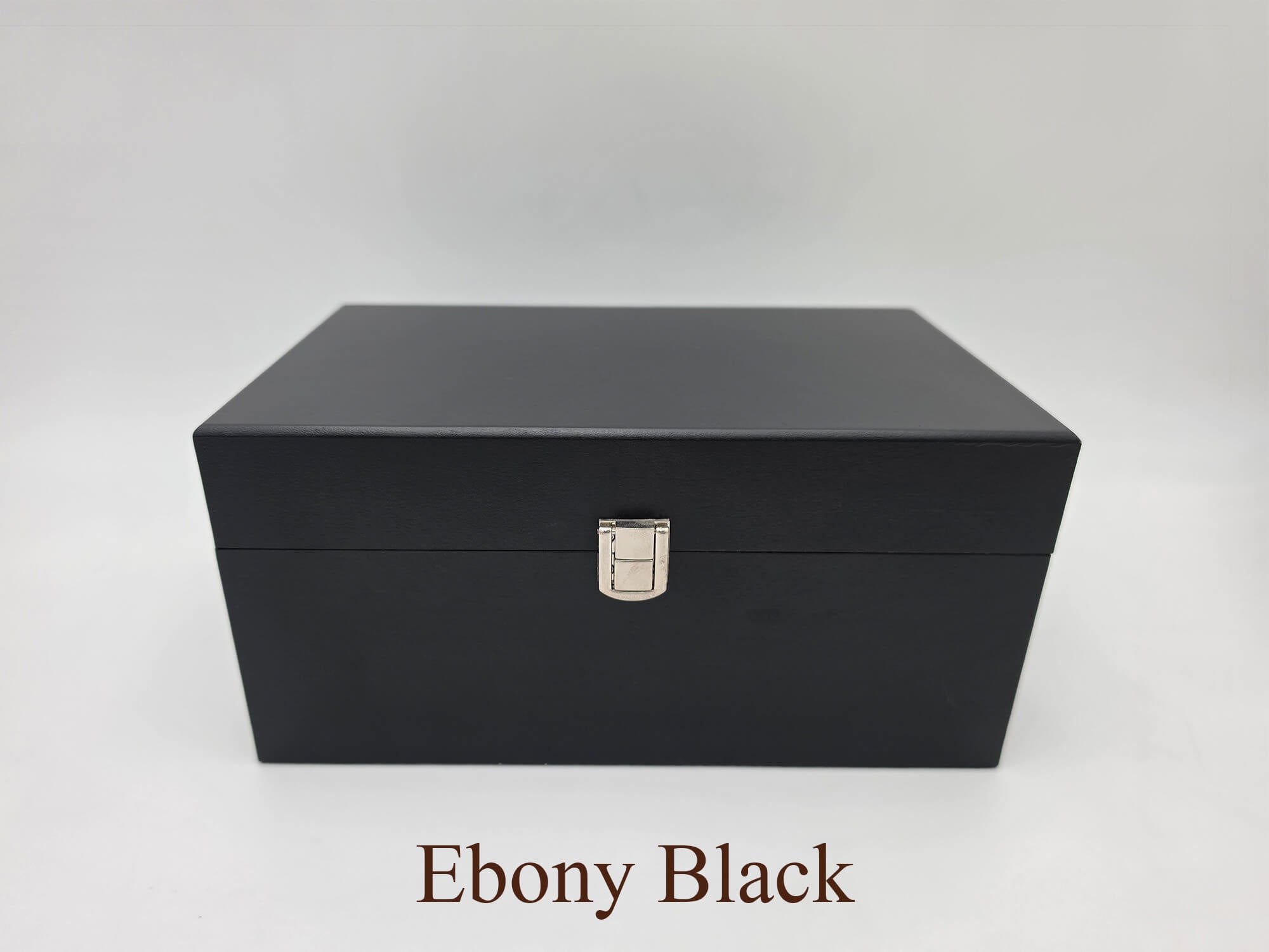 Front view of the closed Monarch ebony black wooden chess storage box featuring dark wood grain and with silver latch.
