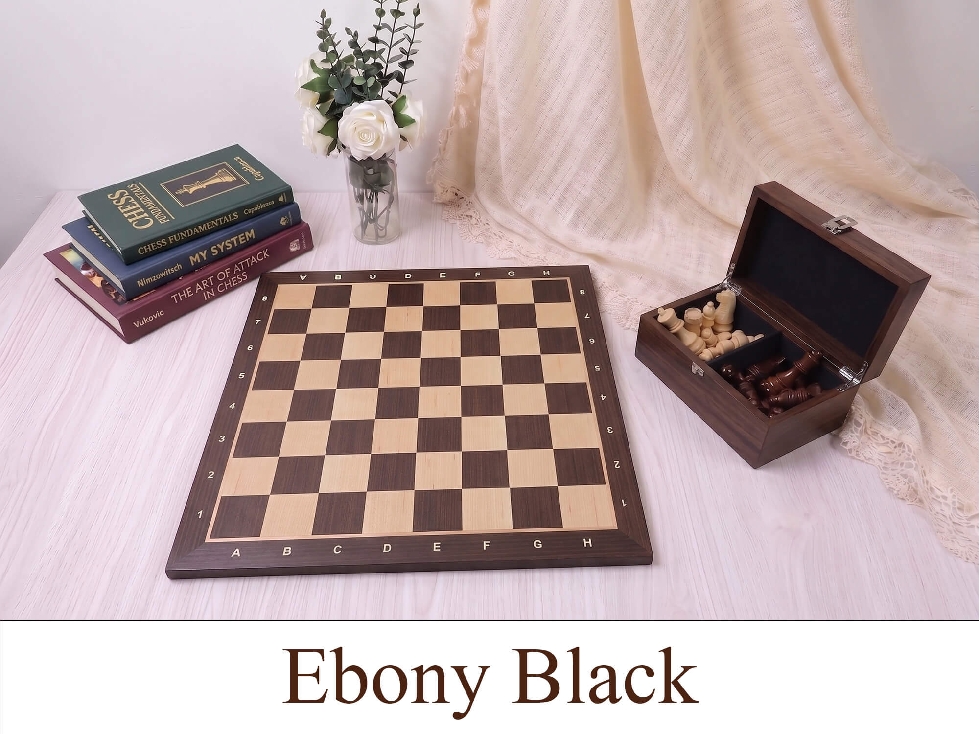Monarch Series engineered ebony wooden chess board with a matching wooden storage box on a beige table, featuring high-contrast maple squares.