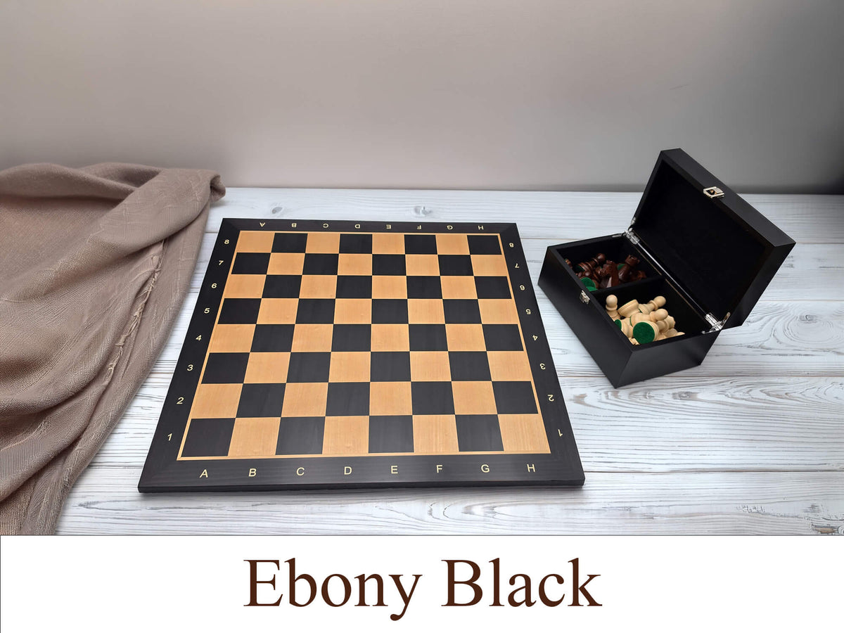 Monarch Series engineered ebony wooden chess board with a matching wooden storage box on a beige table, featuring high-contrast maple squares.