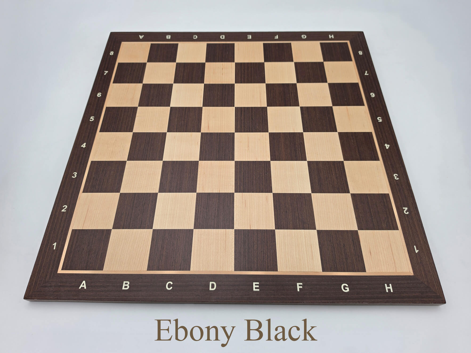 Top-down view of the stunning Monarch Series engineered ebony and maple chess board, featuring high-contrast 57mm squares and clear algebraic notation.