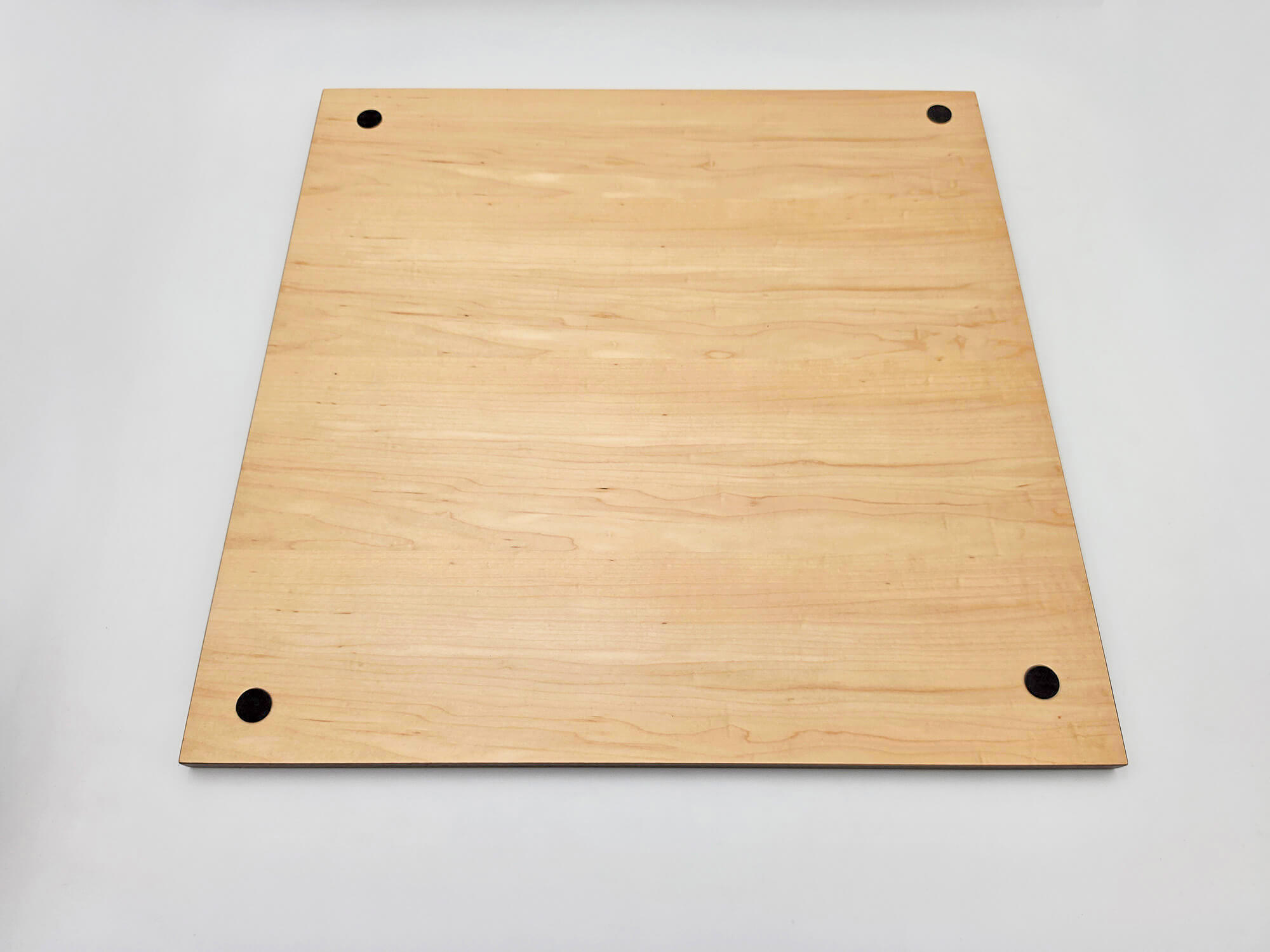 View of the smooth underside of a Monarch wooden chess board, featuring anti-scratch protective corner pads and the robust solid wood frame construction.