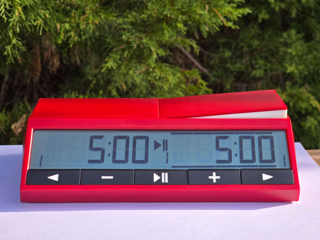 Main front view of red DGT 2500 digital chess clock with 5-minute blitz timer on high-contrast display.