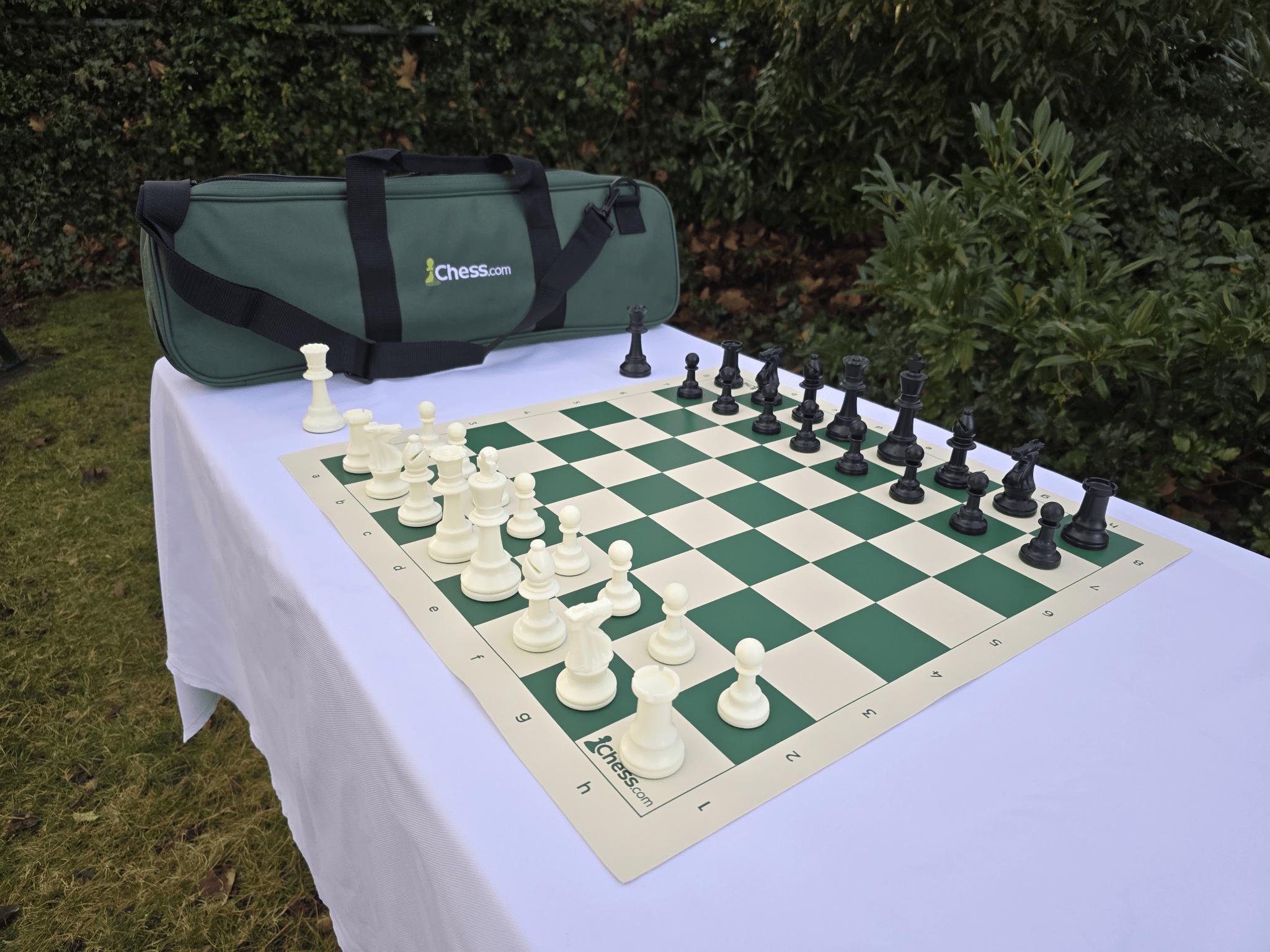 Chess.com Tournament Chess Set and Vinyl Chess Board in Garden (Angled Shot)