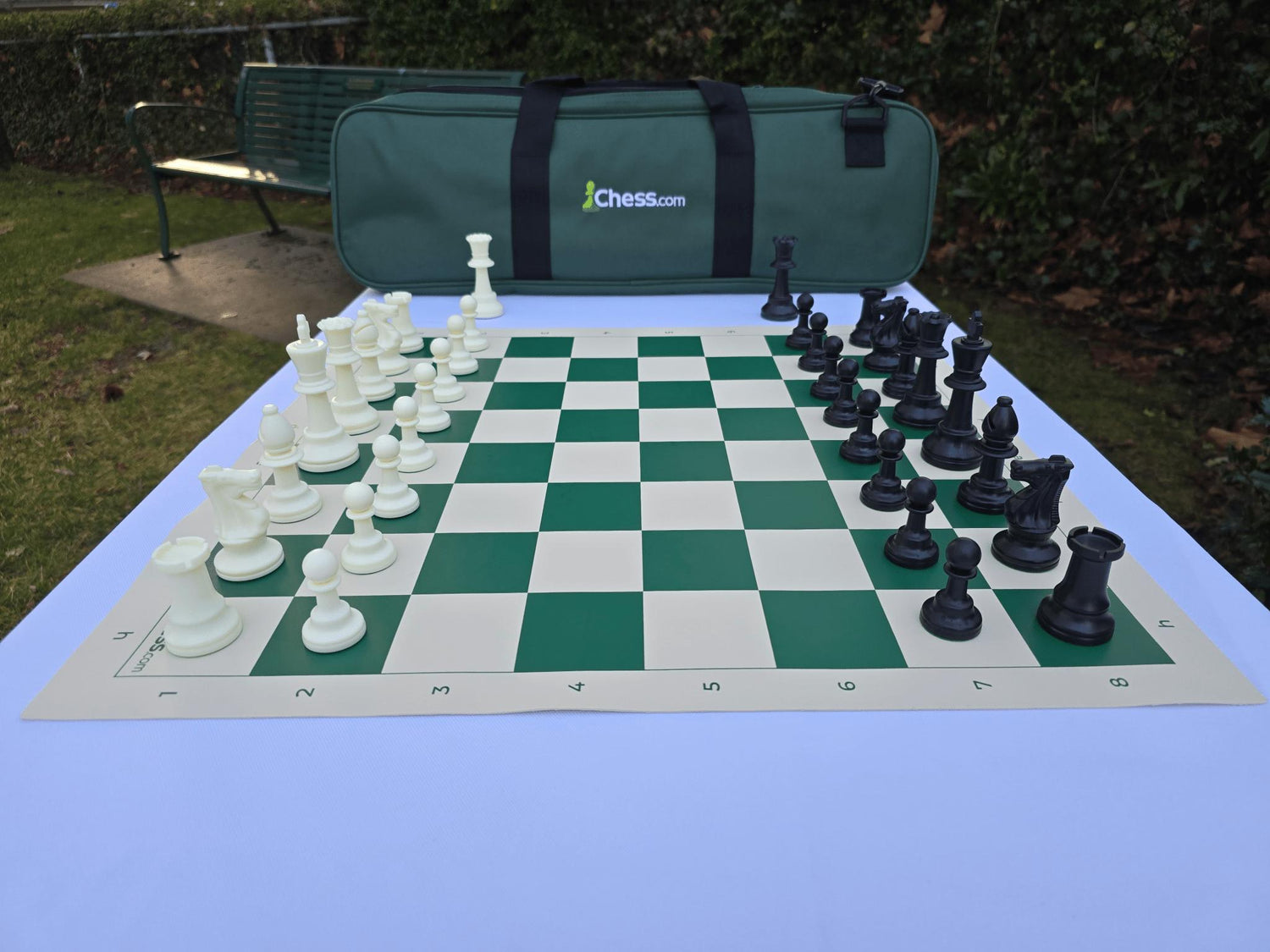 Chess.com Tournament Chess Set and Vinyl Chess Board in Garden (Side Profile)