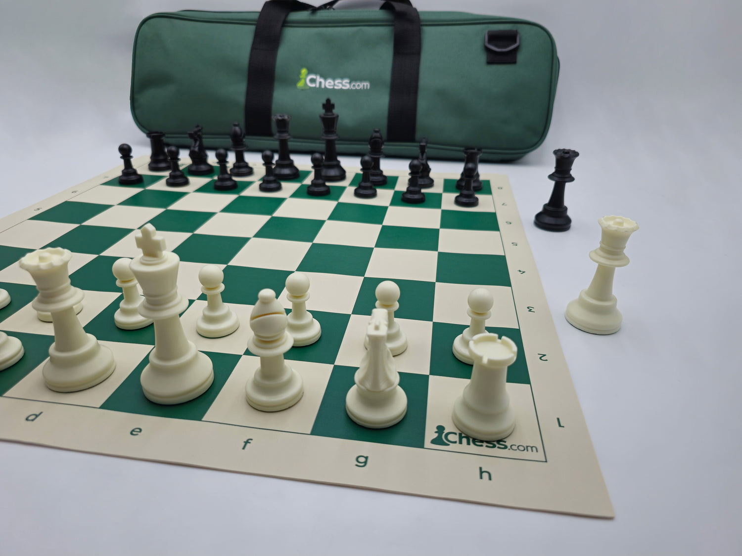 Chess.com Chess Set with Deluxe Bag and Vinyl Chess Board in Light Box (Half-Board Angle showing Logo)