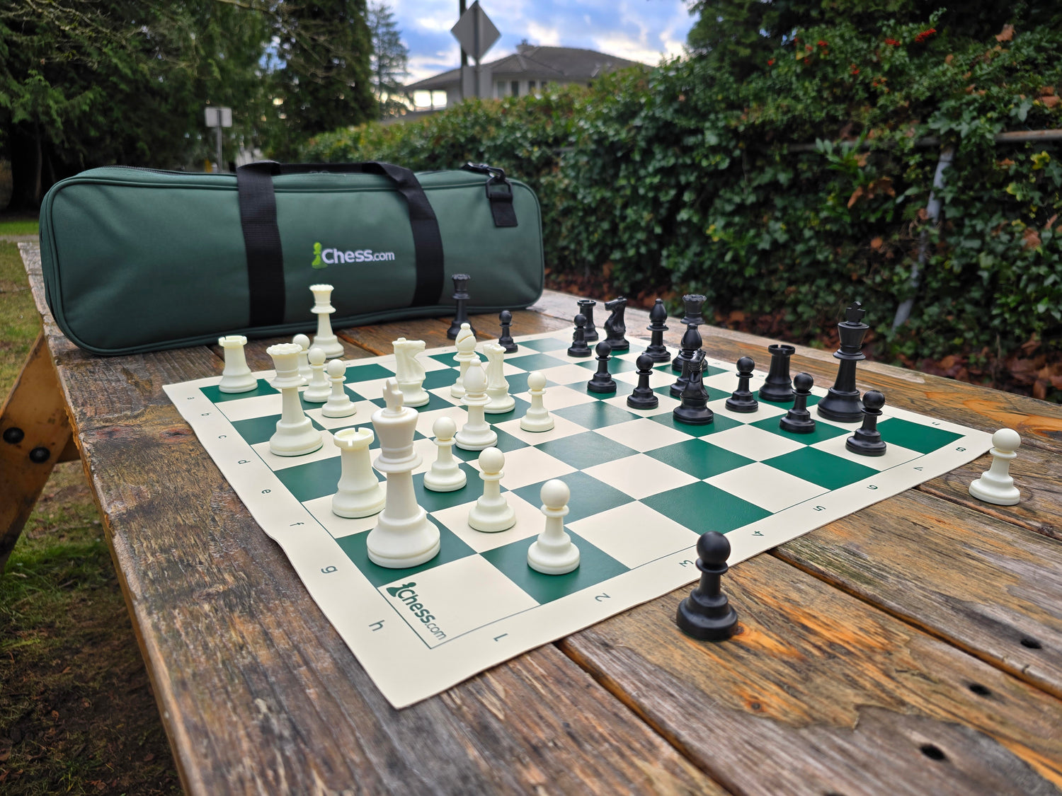 Chess.com Set with Deluxe Bag and Vinyl Chess Board on Park Bench (Angled Shot H1)