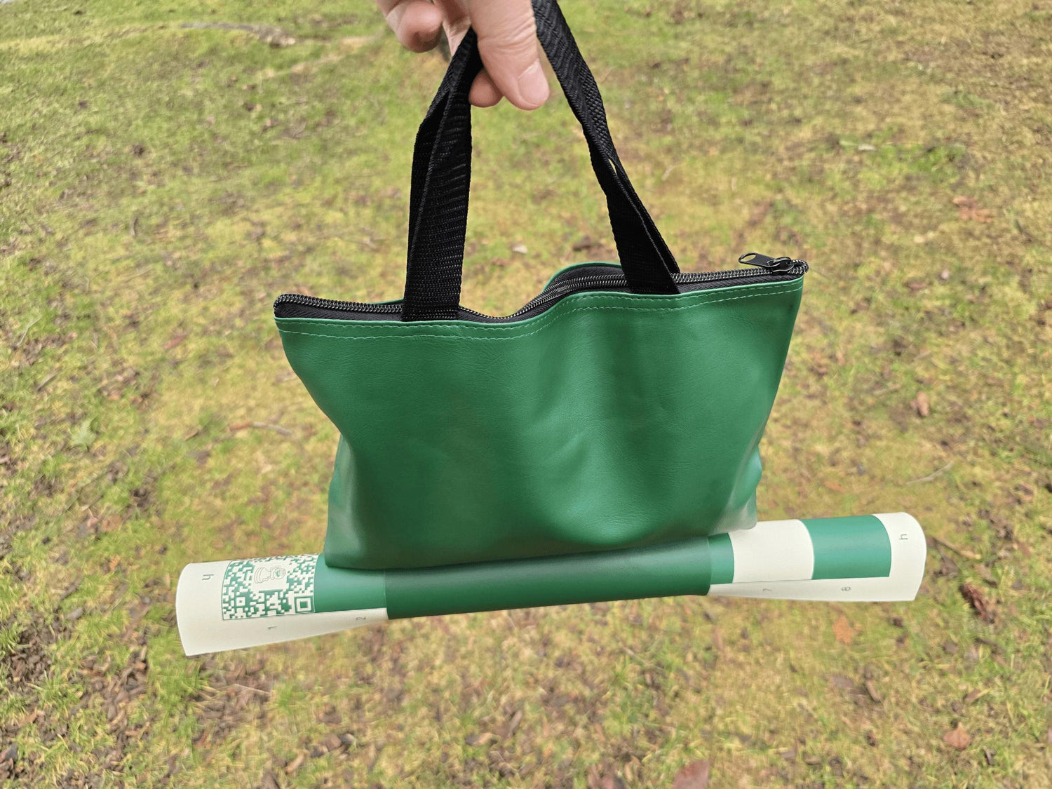 ChessKid Tote Chess Set with Vinyl Chess Board in Protective Sleeve Carried by a Hand