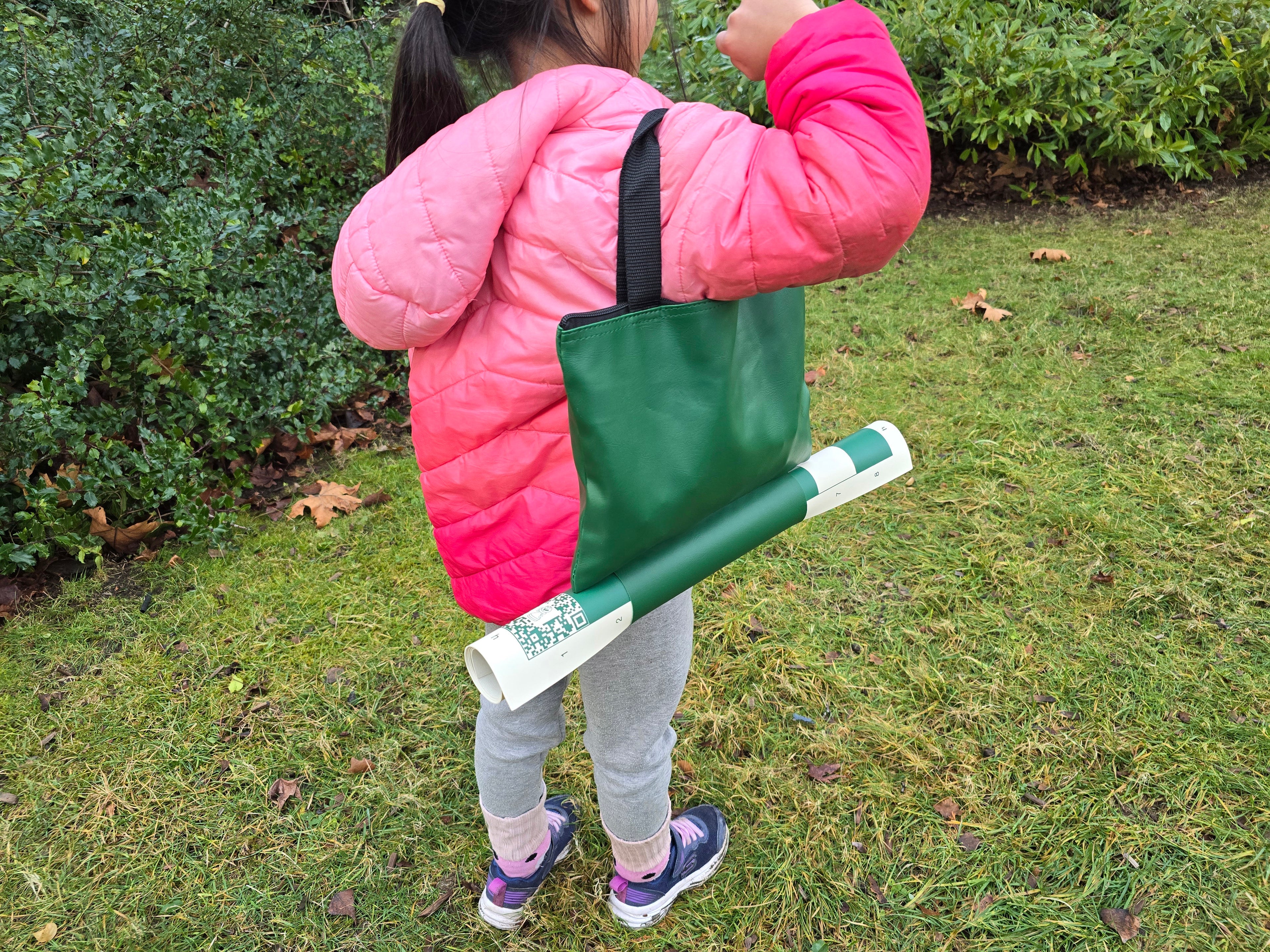 ChessKid Tote Chess Set with Vinyl Chess Board in Protective Sleeve Carried by a Young Child (Rear Shot)
