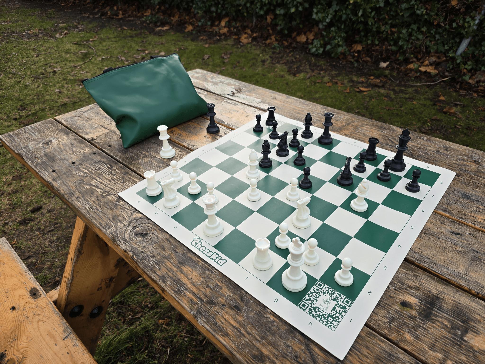 ChessKid Tote Chess Set with Vinyl Chess Board on Park Bench (Angled Shot from White&