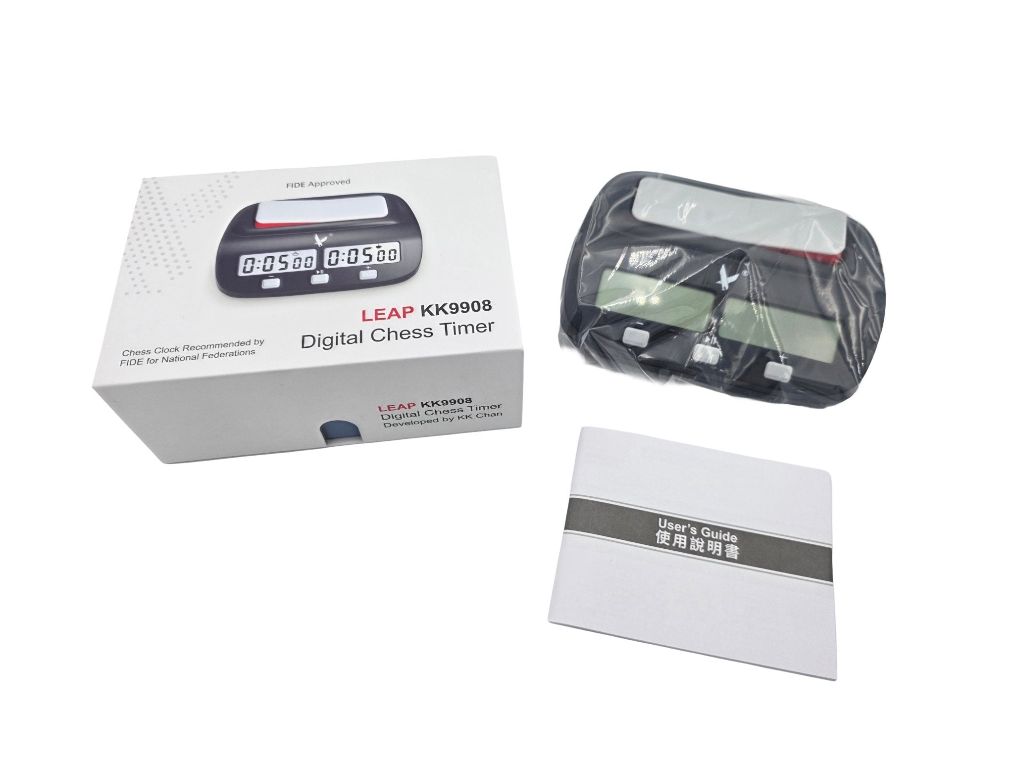 An unboxed Leap KK9908 digital chess clock set including the retail box, the clock in protective plastic wrapping, and a printed user manual.