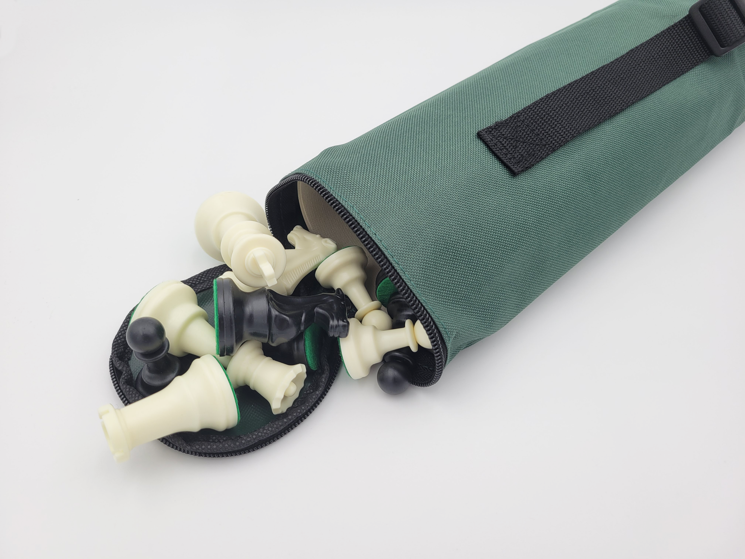 Chess Quiver Carrying Case with Pieces Spilling Out of the Open Top in a Lightbox (Angled Shot)