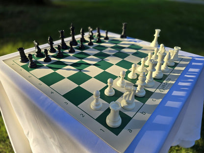 US Chess Federation Tournament Chess Set on a White Cloth Table Against a Grass Background (Angled Shot from White&
