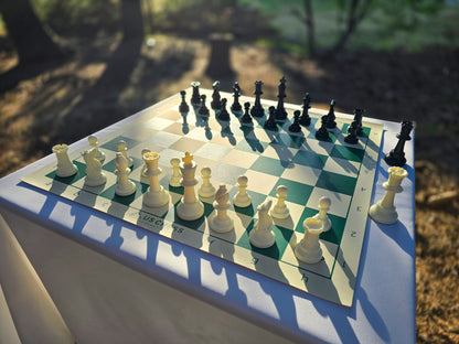 US Chess Federation Tournament Chess Set on USCF Vinyl Chess Board at Twilight with Sunlight Glinting Off the Pieces and Board