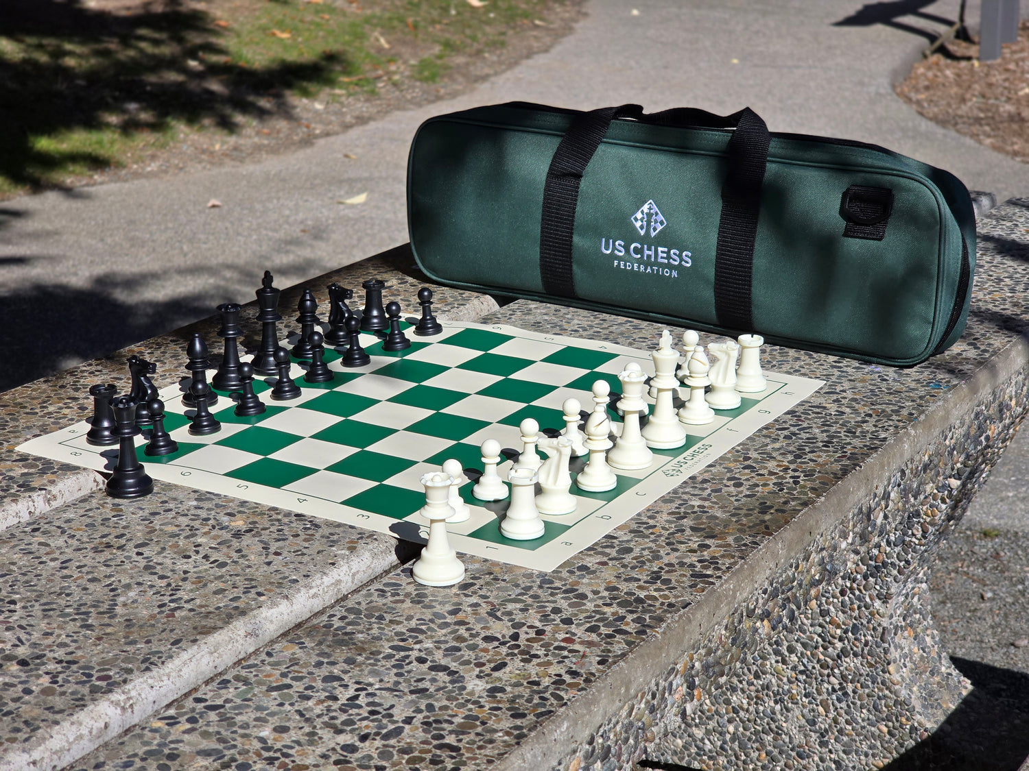 US Chess Federation Tournament Chess Set with Vinyl Chess Board and USCF Deluxe Carrying Case on Stone Table
