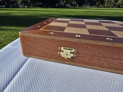 Close-up of the elegant metal clasp latch on the side of the closed Aristocrat folding wooden chess box.