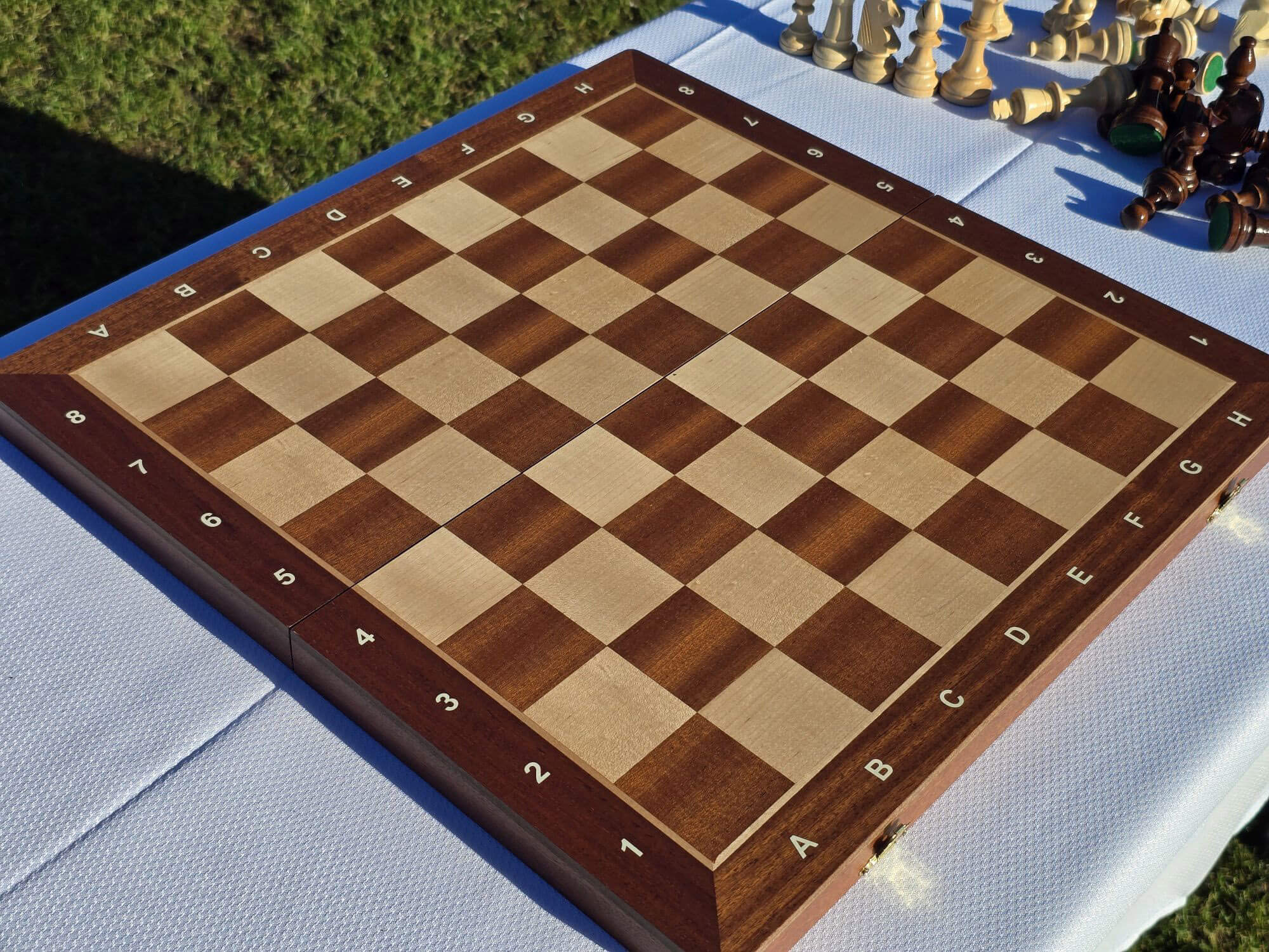 Top-down view of the empty Aristocrat wooden chess board highlighting the contrasting light and dark wood squares.