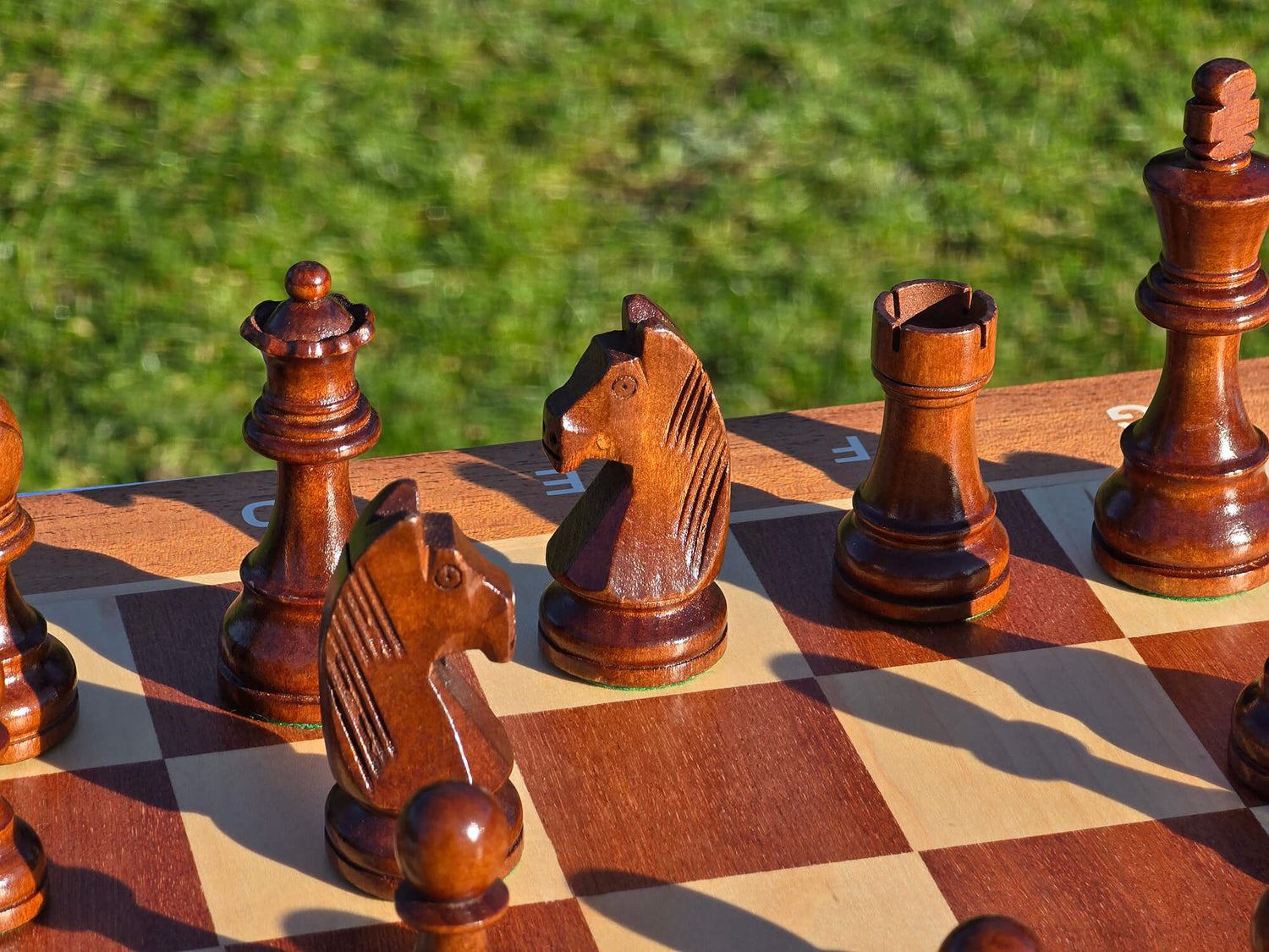 Detailed shot of the black king, queen, rook, and knight pieces from the Monarch wooden set.