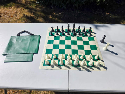 Campaigner Tournament chess set featuring a green roll-up vinyl board, plastic Staunton pieces set up, and matching green zippered tote bag.