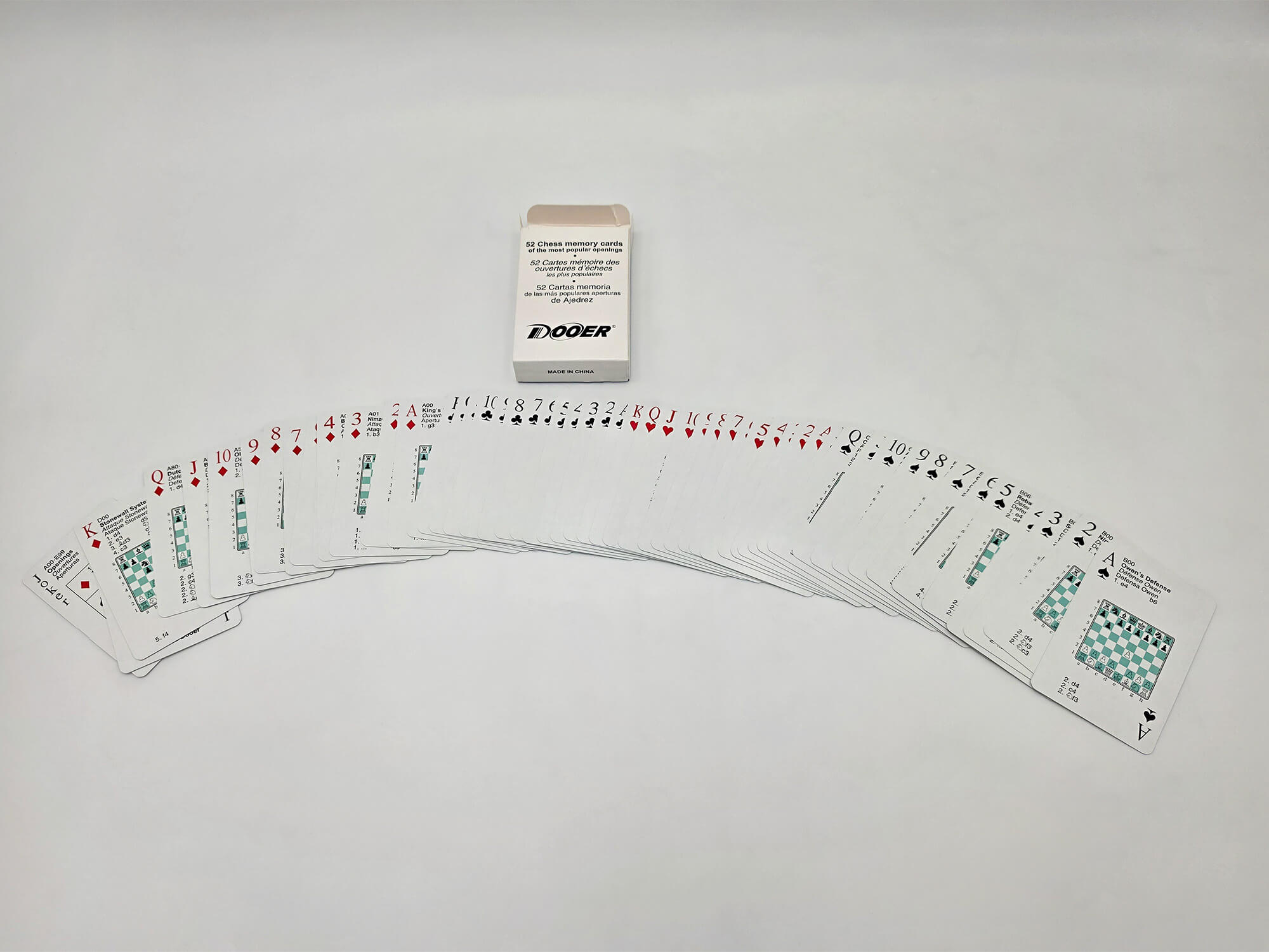 Fanned-out deck of 52 chess opening flashcards showing move notations next to the original box