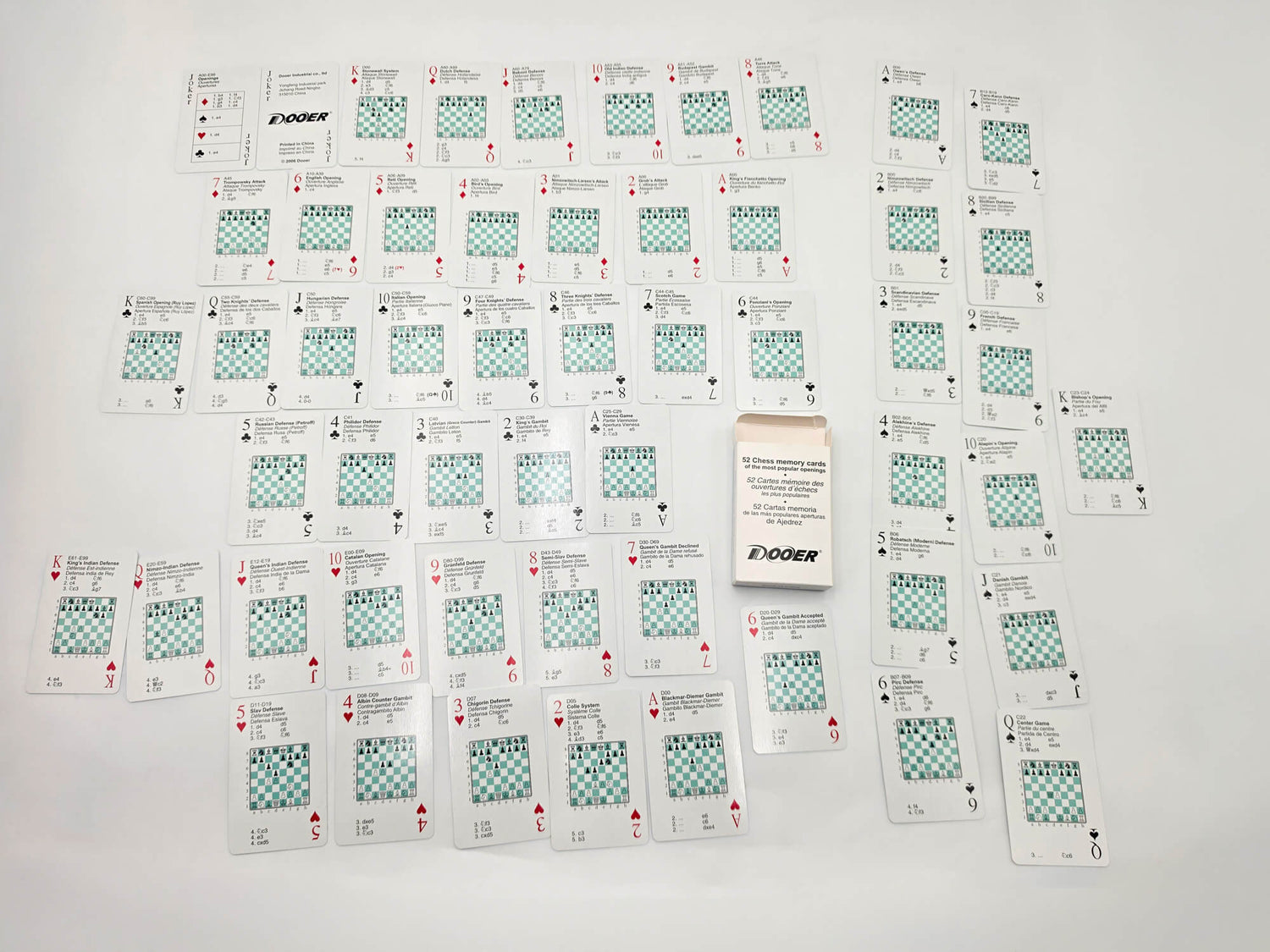 Complete 52 chess opening flashcards set laid out on a white surface with tuck box
