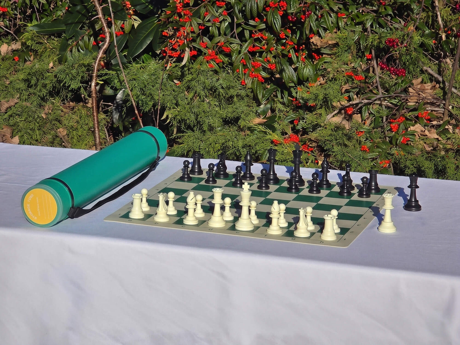 Green Sentry telescopic chess carrying tube with a vinyl chess board and pieces for tournament play.