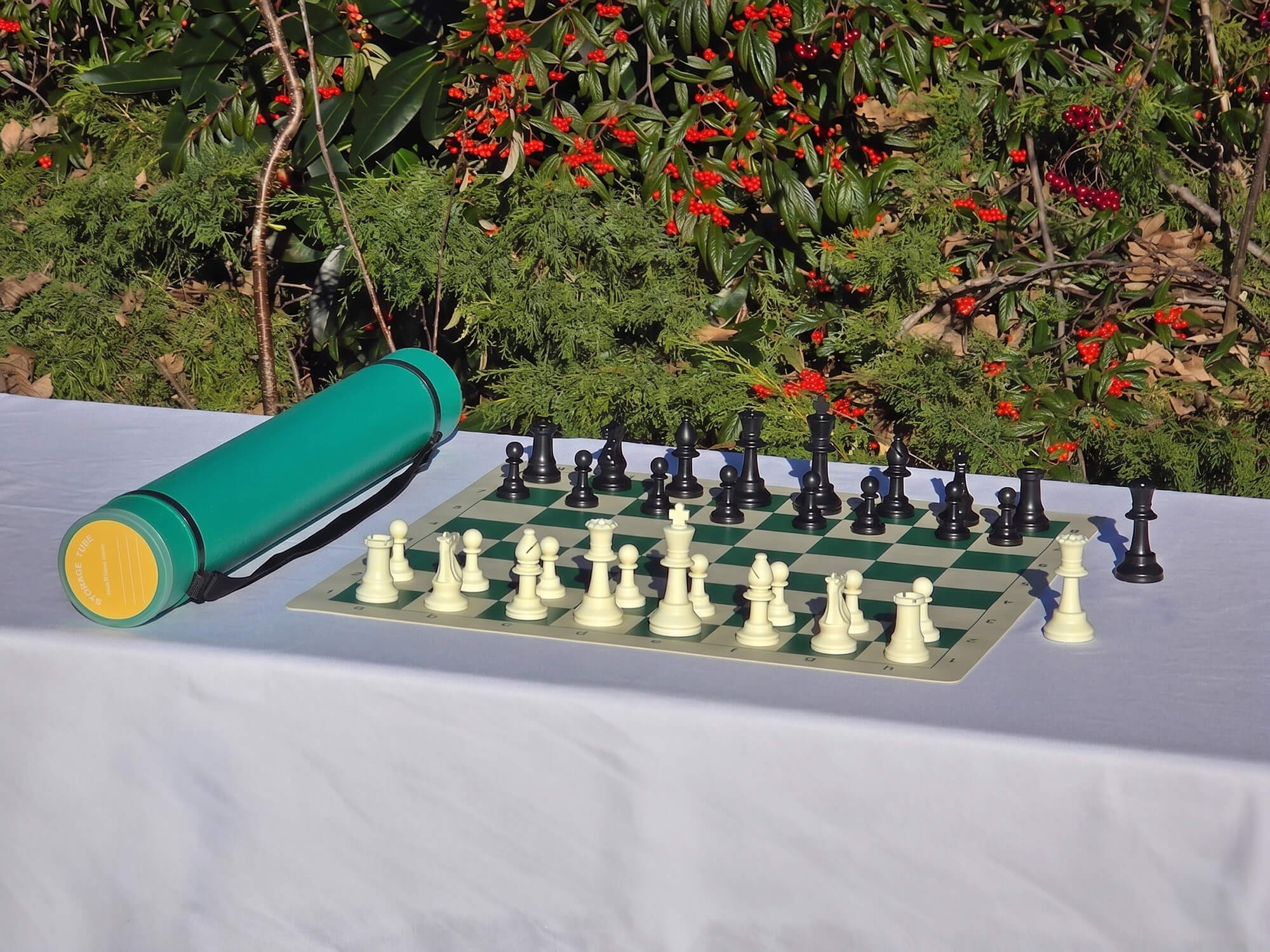Green Sentry telescopic chess carrying tube with a vinyl chess board and pieces for tournament play.