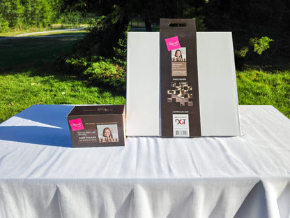 Outdoor display of the Judit Polgar chess set packaging and presentation box on a white table.