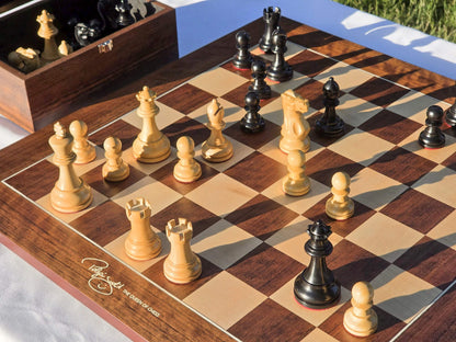 Judit Polgar Queen of Chess signature detail on the corner of the wooden chessboard with pieces in play.