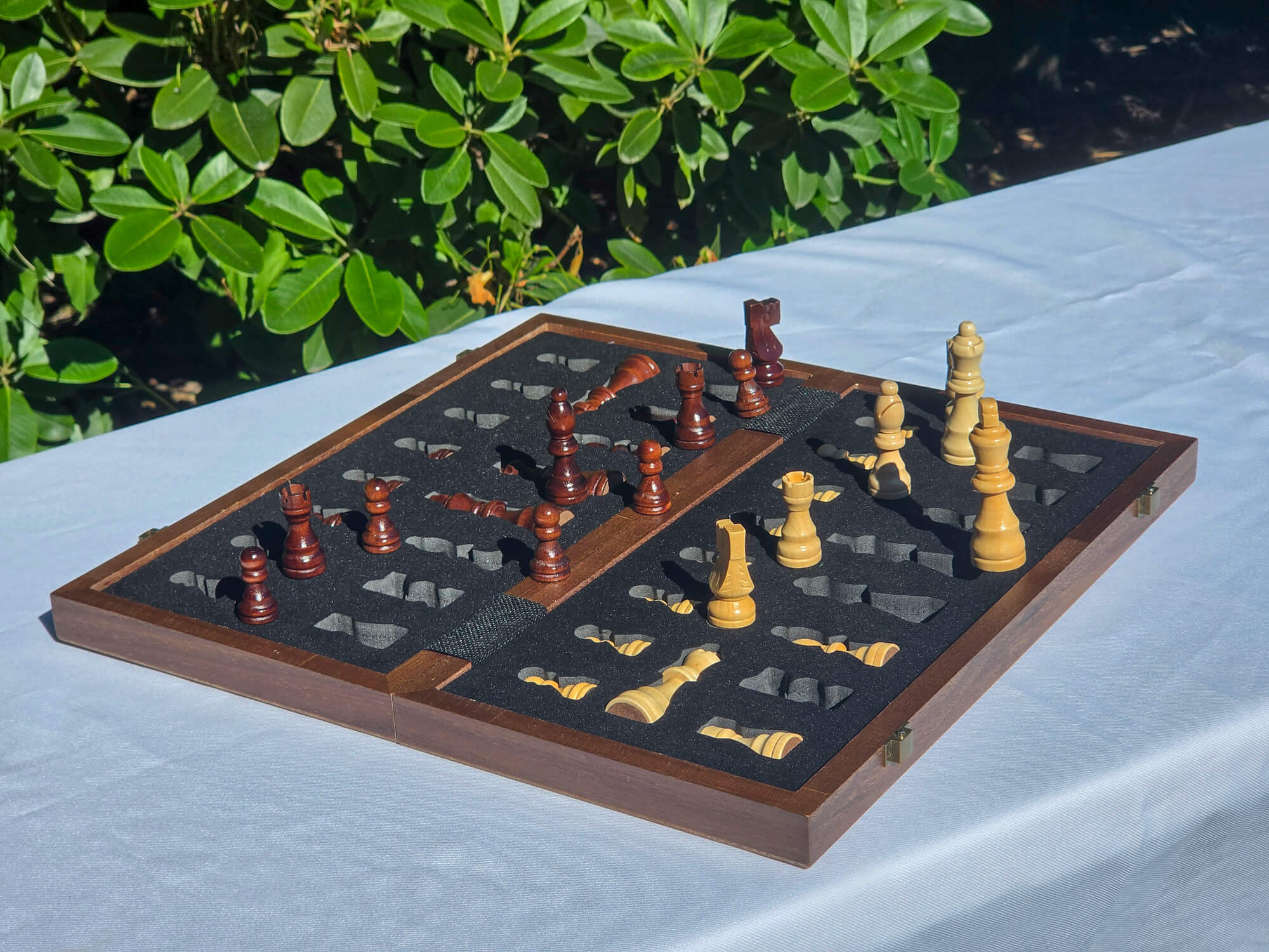Marquis Magnetic Walnut Chess Set open case with some pieces nested in the EVA foam storage tray and others standing up.