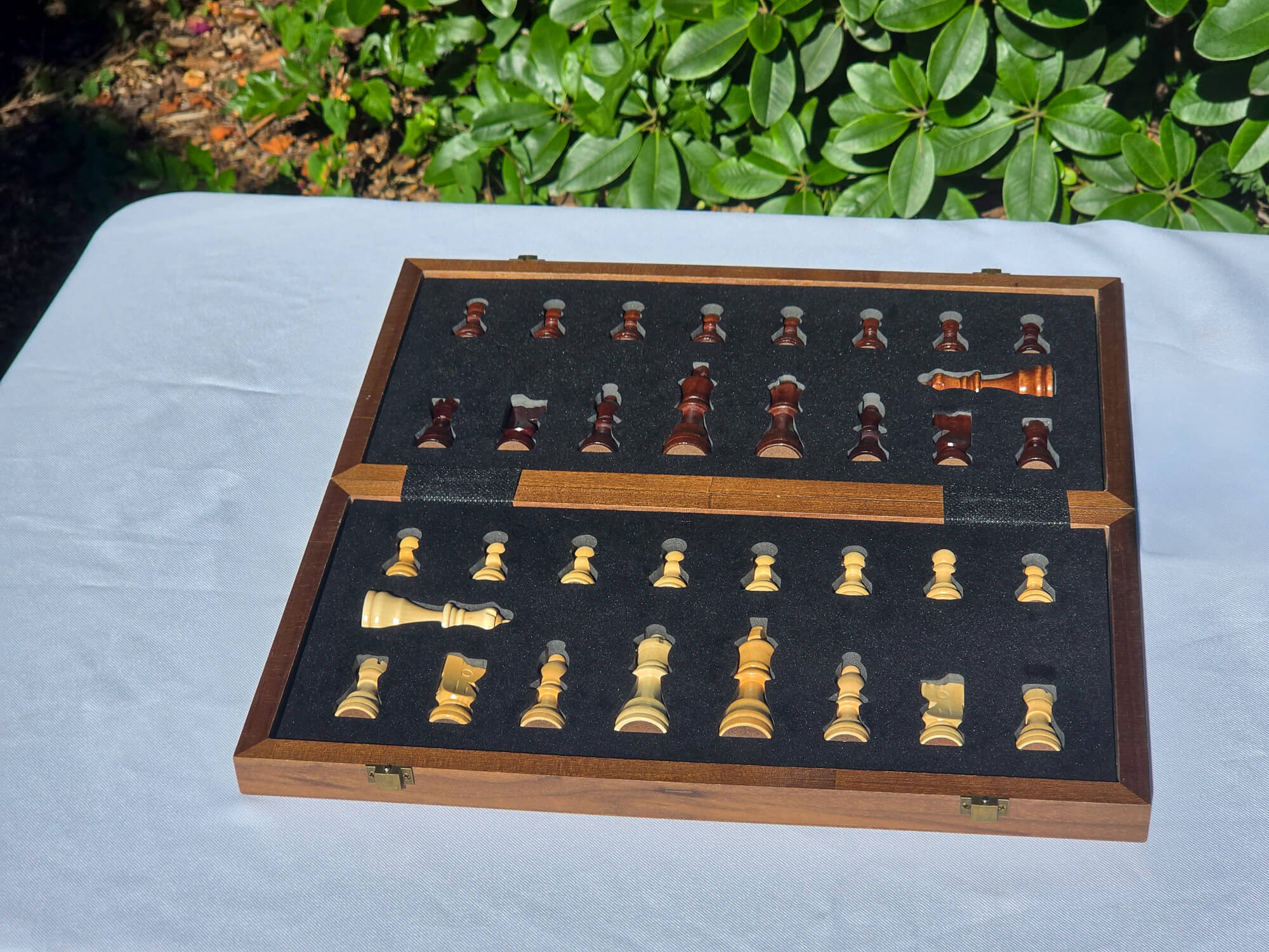 Marquis Magnetic Walnut Chess Set case opened flat showing all 34 pieces organized in the foam tray.
