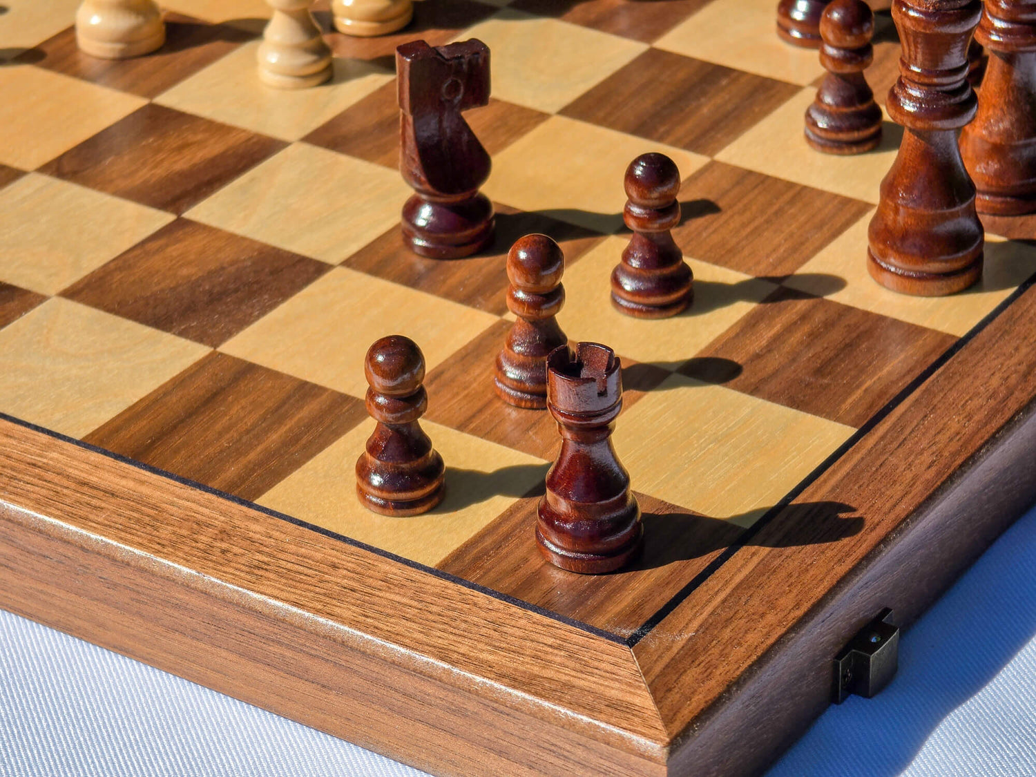 Close-up of dark magnetic Staunton chess pieces on the Marquis Magnetic Walnut Chess Set board