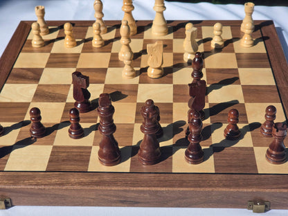 Focused iew of the Marquis Magnetic Walnut folding chess board set up with pieces in play.