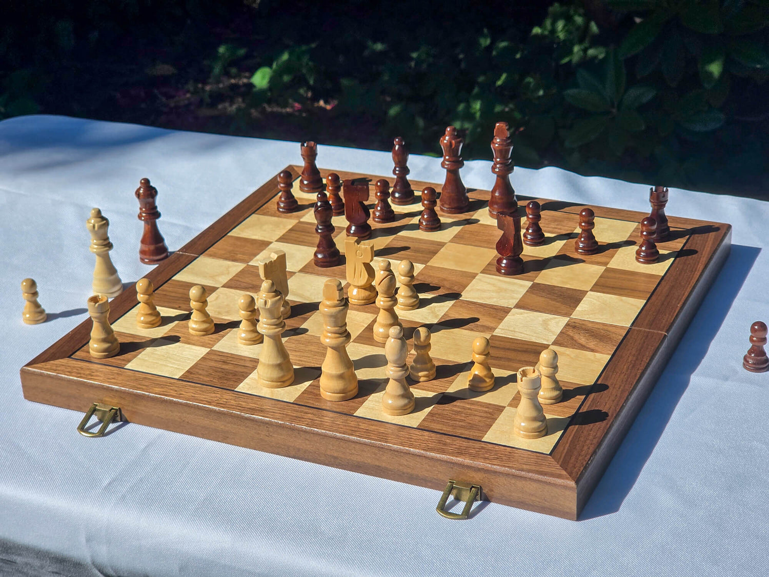 Side angle view of the Marquis Magnetic Wooden Chess Set showing the walnut and maple playing surface