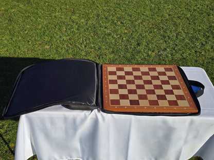 The Monarch padded carrying case with a full-sized wooden chess board tucked securely inside the main sleeve.