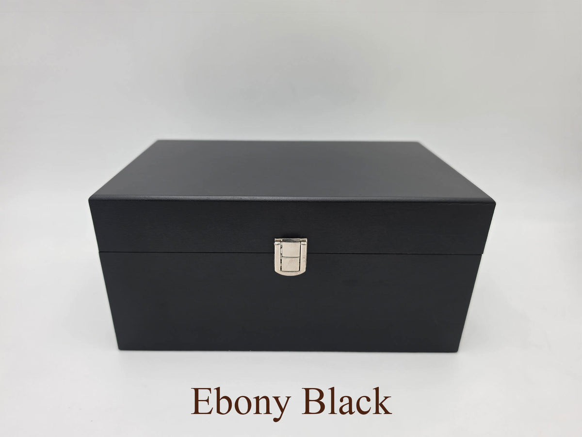 Front view of the closed Monarch ebony black wooden chess storage box featuring dark wood grain and with silver latch.