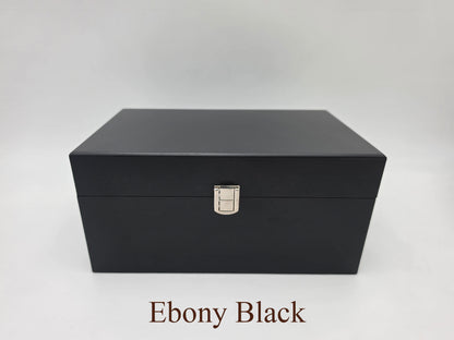 Front view of the closed Monarch ebony black wooden chess storage box featuring dark wood grain and with silver latch.