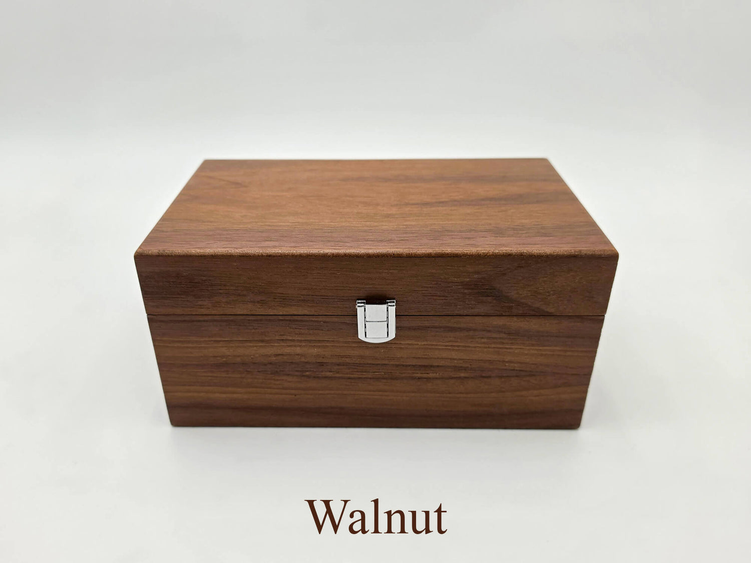 Front view of the closed Monarch walnut wooden chess storage box featuring dark wood grain.