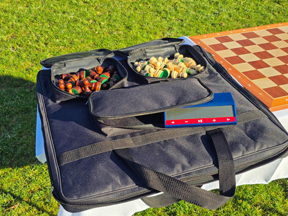 Open Monarch padded chess bag showcasing internal compartments for pieces and a dedicated chess clock slot.
