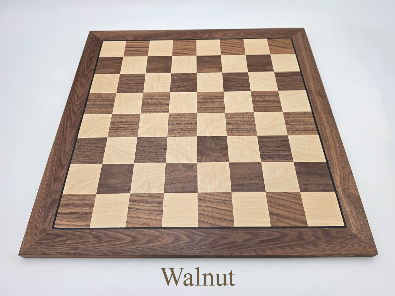 Top-down view of the stunning Monarch Series walnut and maple chess board, featuring high-contrast 57mm squares and clear algebraic notation.