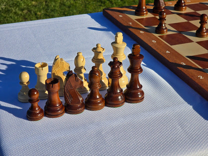 A complete set of handcrafted Monarch wooden chess pieces displayed together.
