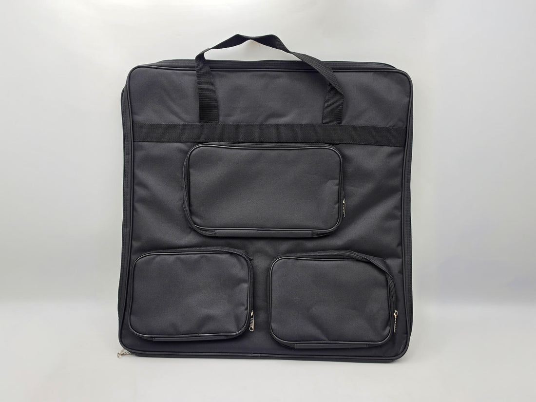 Large black padded carrying bag for the Monarch wooden chess set featuring three external zippered pockets for a chess clock and pieces.