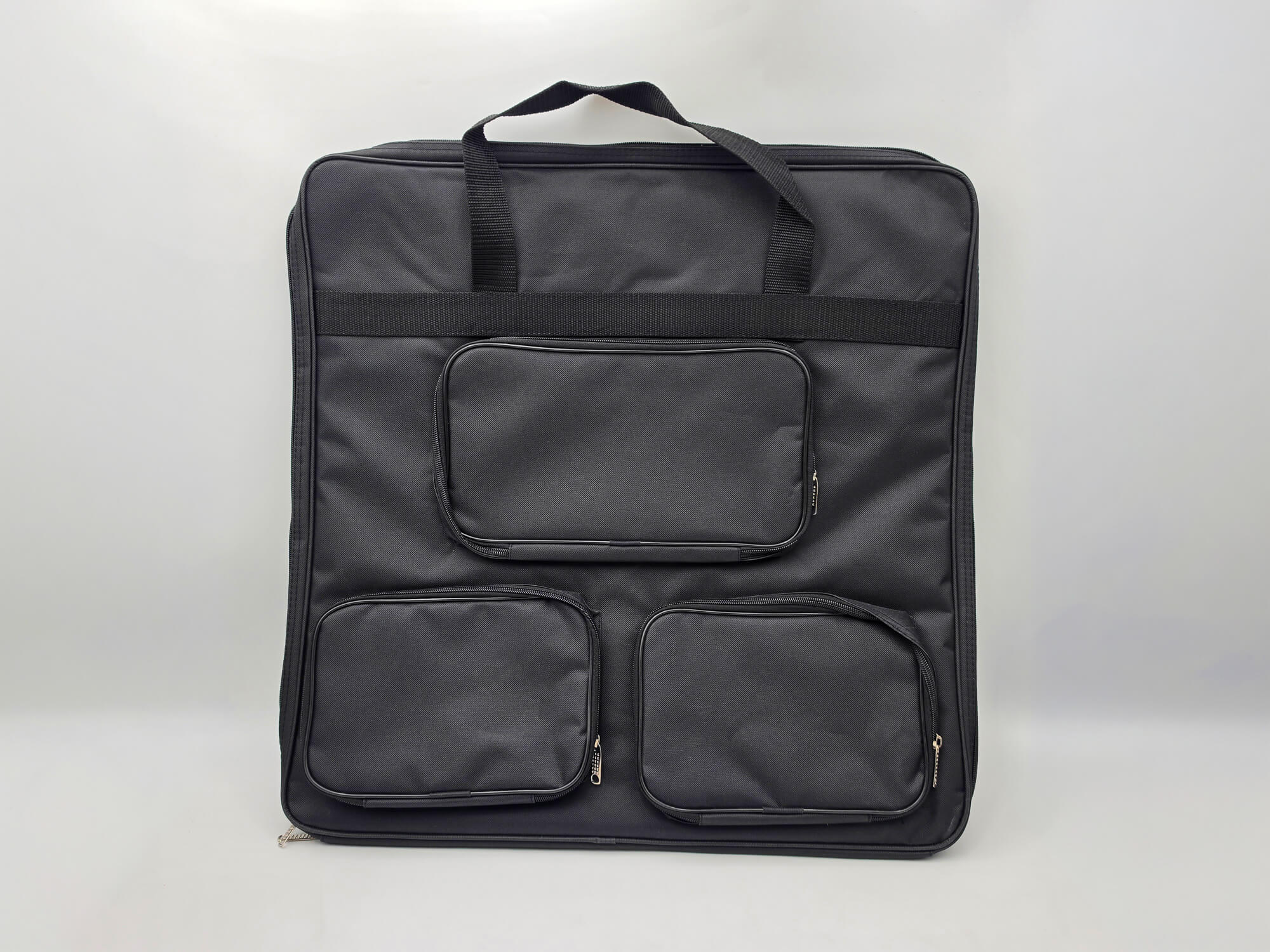 Large black padded carrying bag for the Monarch wooden chess set featuring three external zippered pockets for a chess clock and pieces.