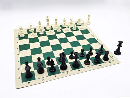 Standard plastic Staunton chess pieces on a green and white roll-up vinyl board with algebraic notation, shown from an isometric view.