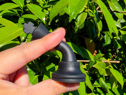 Close-up of a hand bending a rubberized, flexible silicone chess piece showing durability.
