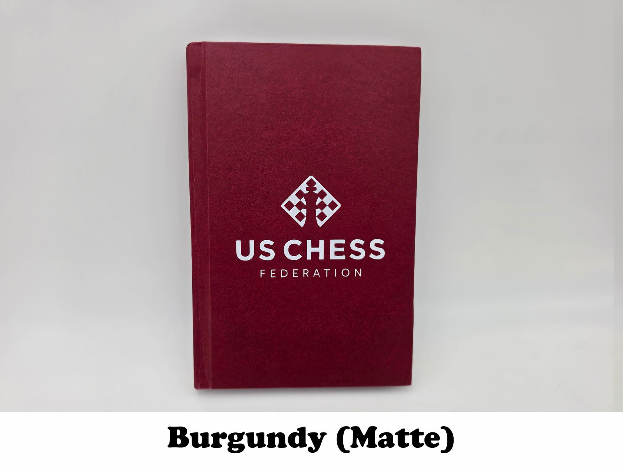 Matte burgundy USCF tournament chess scorebook.